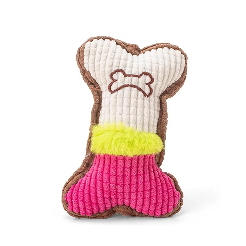 A plush dog toy shaped like a bone, featuring brown and beige fabric with a pink felt interior and yellow fluff.