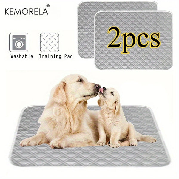 Two light-colored puppies resting on a gray reusable pet training pad.