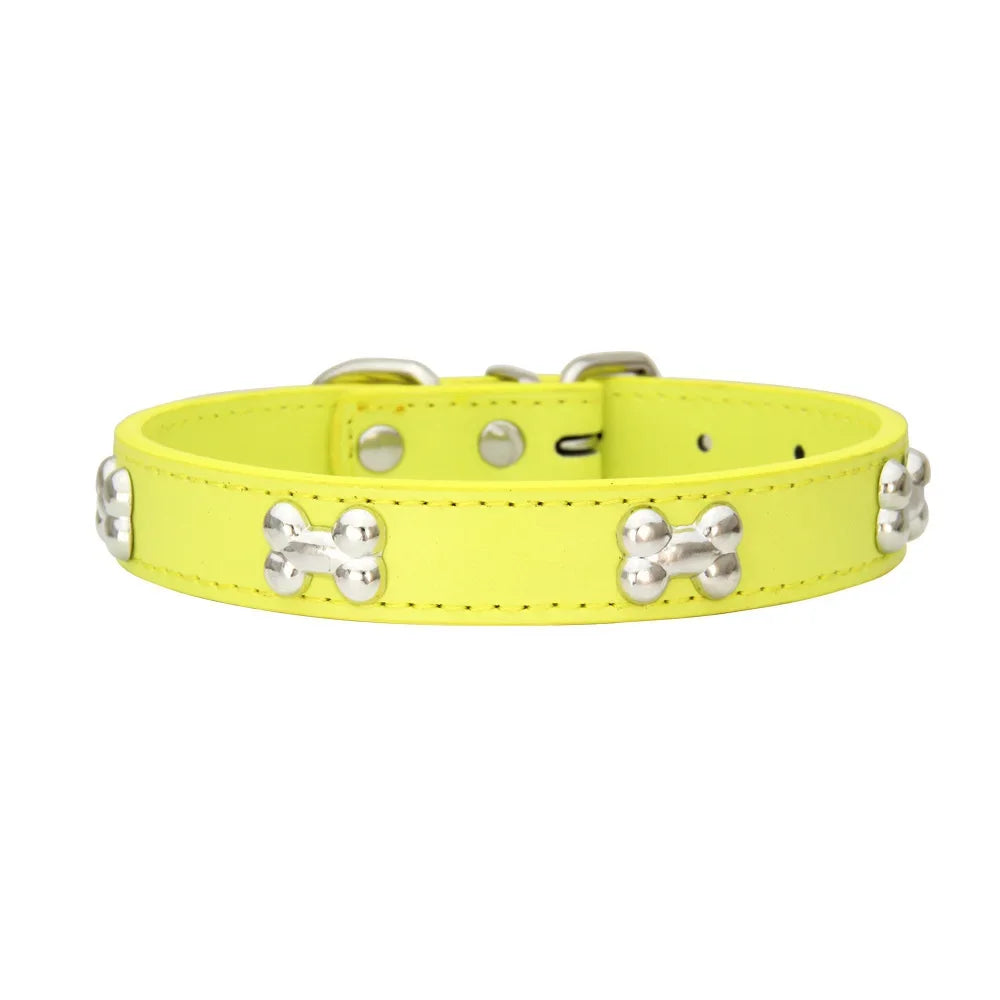 A bright yellow padded leather dog collar with silver bone rivets and a buckle.