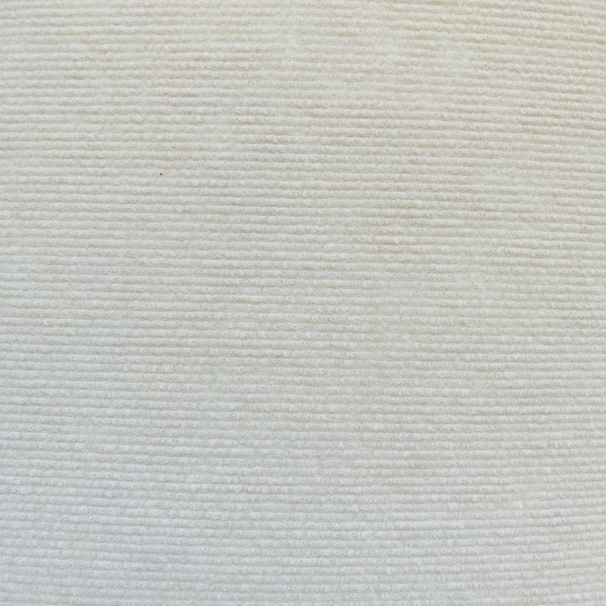 A close-up texture of a white self-adhesive cat scratching mat fabric.