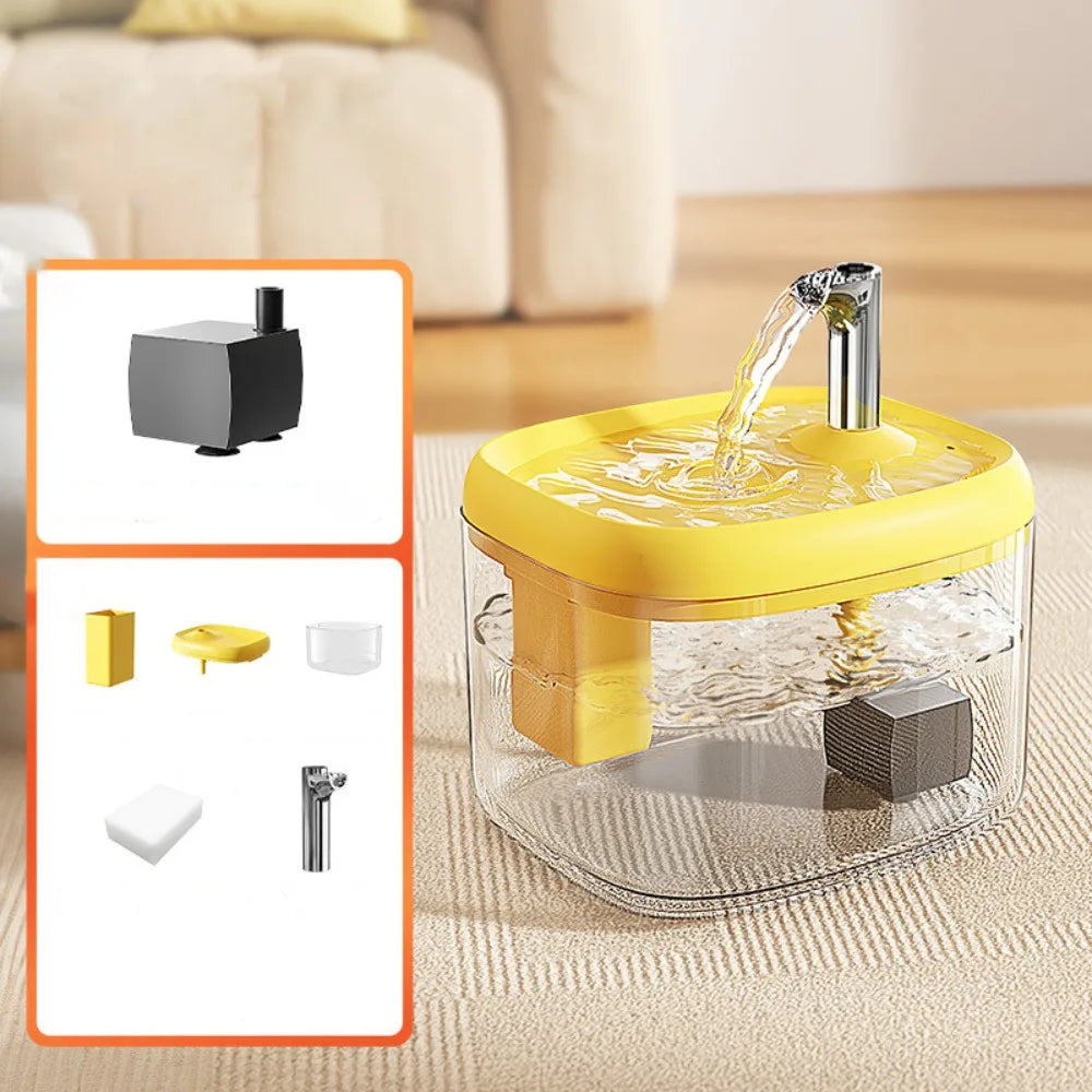 A clear pet drinking fountain with a yellow base and a metal spout is shown on a light-colored surface.