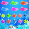 A colorful set of ten soft rubber goldfish bath toys in various shades of pink, orange, green, and blue swimming in blue wate