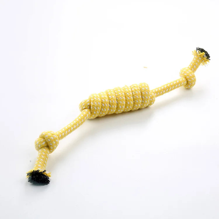 A yellow braided cotton rope chew toy for dogs with black frayed ends.