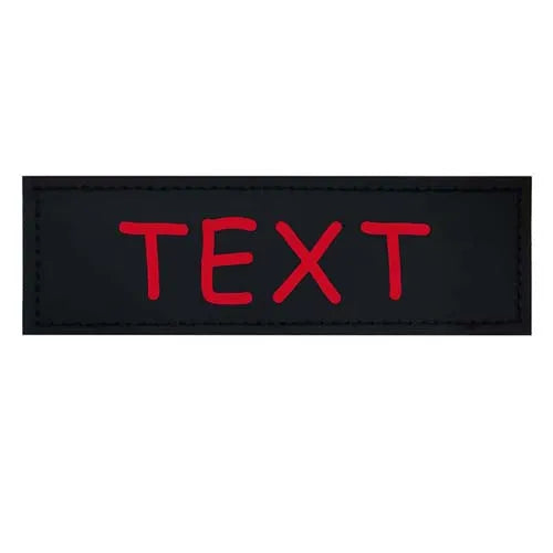 Black leather dog harness tag with the word TEXT printed in red capital letters