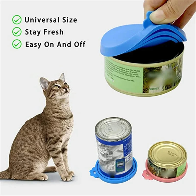 A reusable silicone pet food can lid and spoon shown next to a tabby cat.