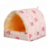 A pink flannel pet nest bed with a yellow interior and pink fruit patterns.