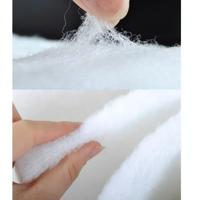 A hand is squeezing a white, porous sponge material used as an aquarium biochemical filter.
