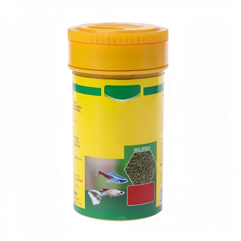 Conteneur jaune et vert de nourriture pour poissons tropicales enrichie en Spiruline
