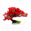 A vibrant red aquarium plant and rock decor set featuring dense foliage on a dark base.
